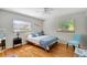 Charming bedroom features hardwood floors, a ceiling fan, and two windows bringing in lots of natural light at 9503 Alice Ln, Riverview, FL 33578