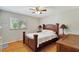 Bedroom with hardwood floors, ceiling fan, and natural light, creating a comfortable and serene space at 9503 Alice Ln, Riverview, FL 33578