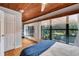 Light-filled bedroom boasting natural light, hardwood floors, and views of a canal at 9503 Alice Ln, Riverview, FL 33578