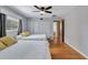 Well-lit bedroom featuring hardwood floors, 2 beds, white closet, and a window at 9503 Alice Ln, Riverview, FL 33578