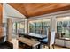 Stylish dining area with large windows and a view, bench seating, and modern lighting fixtures at 9503 Alice Ln, Riverview, FL 33578