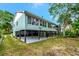 Exterior of home featuring ample space beneath the raised house and a spacious backyard at 9503 Alice Ln, Riverview, FL 33578