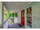 Inviting covered porch with a decorative front door and etched glass sidelight for added curb appeal at 9503 Alice Ln, Riverview, FL 33578