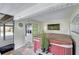 Enclosed hot tub room with tiled floors, adjacent to the home's carport and open space at 9503 Alice Ln, Riverview, FL 33578