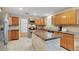 Well-lit kitchen featuring stainless steel appliances and stone countertops at 9503 Alice Ln, Riverview, FL 33578