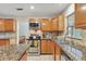 Bright kitchen with stainless steel appliances and mosaic backsplash at 9503 Alice Ln, Riverview, FL 33578