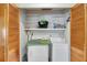 A laundry area with stacked washer and dryer and shelving at 9503 Alice Ln, Riverview, FL 33578