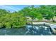 Waterfront view features mature trees, seawall, and serene reflections in the calm canal at 9503 Alice Ln, Riverview, FL 33578