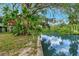A picturesque view of the tranquil canal with lush greenery and reflections in the water at 9503 Alice Ln, Riverview, FL 33578