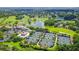 Expansive aerial view showcasing lush landscaping, a serene lake, and pristine tennis courts, highlighting community at 112 Osprey Point Dr, Osprey, FL 34229