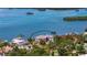 Aerial view showcases this waterfront estate with circular drive and lush landscaping at 112 Osprey Point Dr, Osprey, FL 34229