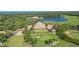 Aerial view of a golf course and clubhouse in a luxury community with lush landscapes at 112 Osprey Point Dr, Osprey, FL 34229
