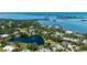 Waterfront estate with an amazing water view, lush landscaping, and a serene pond nearby at 112 Osprey Point Dr, Osprey, FL 34229