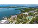 Aerial view of waterfront estate with beautiful landscaping, private dock, and access to open water at 112 Osprey Point Dr, Osprey, FL 34229