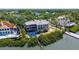 An aerial shot of a large waterfront home, in-ground swimming pool, lush landscaping, and private dock at 112 Osprey Point Dr, Osprey, FL 34229