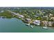 Beautiful waterfront home with private dock and boat lift in a lushly landscaped community at 112 Osprey Point Dr, Osprey, FL 34229