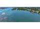 Stunning aerial view of waterfront property with docks and boat lifts, surrounded by lush greenery at 112 Osprey Point Dr, Osprey, FL 34229