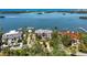 Aerial view of a waterfront home with meticulously manicured landscaping, and a private boat dock at 112 Osprey Point Dr, Osprey, FL 34229
