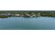 Scenic aerial view of an estate home with private docks on a tranquil waterfront setting at 112 Osprey Point Dr, Osprey, FL 34229