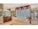 Relaxing bathroom featuring a soaking tub on a raised platform and a vanity with cabinet storage at 112 Osprey Point Dr, Osprey, FL 34229