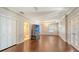 Expansive bedroom with hardwood floors, ceiling fans, and decorative wallpaper, leading to bathroom at 112 Osprey Point Dr, Osprey, FL 34229