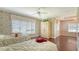 Classic bedroom featuring two beds, hardwood floors, ceiling fan, and elegant wallpaper at 112 Osprey Point Dr, Osprey, FL 34229