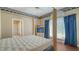 Bright bedroom with natural light, four poster bed, and an ensuite bathroom at 112 Osprey Point Dr, Osprey, FL 34229