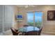 Bright breakfast nook features water views, a round glass table, and seating for four at 112 Osprey Point Dr, Osprey, FL 34229