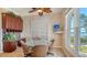 Light-filled breakfast nook featuring a glass table, a ceiling fan, and tranquil water views at 112 Osprey Point Dr, Osprey, FL 34229