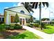 Charming clubhouse exterior with manicured lawns, decorative shrubbery, and a sign reading Locker Room at 112 Osprey Point Dr, Osprey, FL 34229