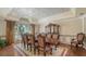 Formal dining room with decorative ceiling, wooden table, and seating for eight at 112 Osprey Point Dr, Osprey, FL 34229