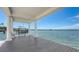 View of a covered boat dock with a boat lift and bench seating providing access to open water at 112 Osprey Point Dr, Osprey, FL 34229