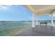 Stunning dock view with bench seating and open water views with a white-columned covered roof at 112 Osprey Point Dr, Osprey, FL 34229