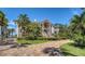 Beautiful estate featuring a circular driveway, lush landscaping, and an impressive facade at 112 Osprey Point Dr, Osprey, FL 34229