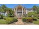 Elegant estate with stately columns, a private balcony, and meticulously manicured landscaping at 112 Osprey Point Dr, Osprey, FL 34229