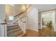 Grand foyer with decorative staircase, hardwood floors, and views into the formal dining room at 112 Osprey Point Dr, Osprey, FL 34229