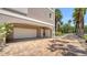 Two-car garage with brick paved driveway and well-maintained landscaping, offers ample parking at 112 Osprey Point Dr, Osprey, FL 34229