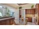 Spacious kitchen with custom cabinets, granite countertops, and an island cooktop at 112 Osprey Point Dr, Osprey, FL 34229