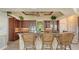Kitchen with a granite counter bar and matching barstools under an ornate, decorative ceiling at 112 Osprey Point Dr, Osprey, FL 34229
