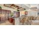 Kitchen with a granite counter bar and matching barstools beneath a stylish, decorative ceiling at 112 Osprey Point Dr, Osprey, FL 34229