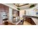 Modern kitchen with stainless steel appliances, dark cabinets, and island cooktop at 112 Osprey Point Dr, Osprey, FL 34229