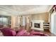 Elegant living room with a stone fireplace, hardwood floors, and multiple entryways to other rooms at 112 Osprey Point Dr, Osprey, FL 34229