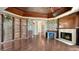 Elegant living room features built-in bookcases, fireplace, and beautiful decorative ceiling at 112 Osprey Point Dr, Osprey, FL 34229