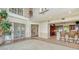 Open-concept living room that connects to the kitchen, with floor-to-ceiling windows and sliding doors at 112 Osprey Point Dr, Osprey, FL 34229