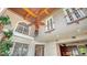 Living room with floor-to-ceiling windows that complement the textured walls and coffered ceilings at 112 Osprey Point Dr, Osprey, FL 34229