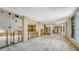 Interior view of gutted living space, featuring exposed walls and open layout for renovations at 112 Osprey Point Dr, Osprey, FL 34229