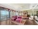 Well-lit primary bedroom with wood floors, a four-poster bed, and sliding doors to a balcony at 112 Osprey Point Dr, Osprey, FL 34229