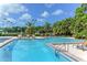 Community pool with ample lounge seating, lush landscaping, and well-maintained pool deck for relaxation at 112 Osprey Point Dr, Osprey, FL 34229