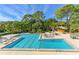 Inviting swimming pool surrounded by lush landscaping and comfortable lounge chairs, perfect for relaxation at 112 Osprey Point Dr, Osprey, FL 34229