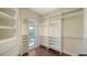 Spacious walk-in closet with custom shelving and a window providing natural light at 112 Osprey Point Dr, Osprey, FL 34229
